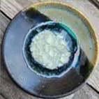 Dock 6 Pottery Black Pearl ceramic ring dish with fused glass center