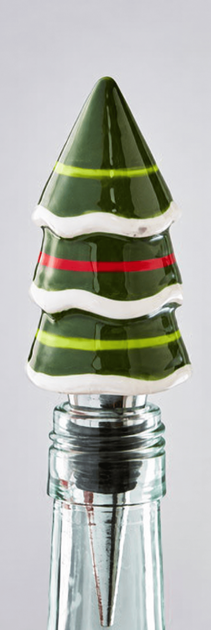 Cheerful Tree Bottle Stopper shown in the neck of a clear glass bottle