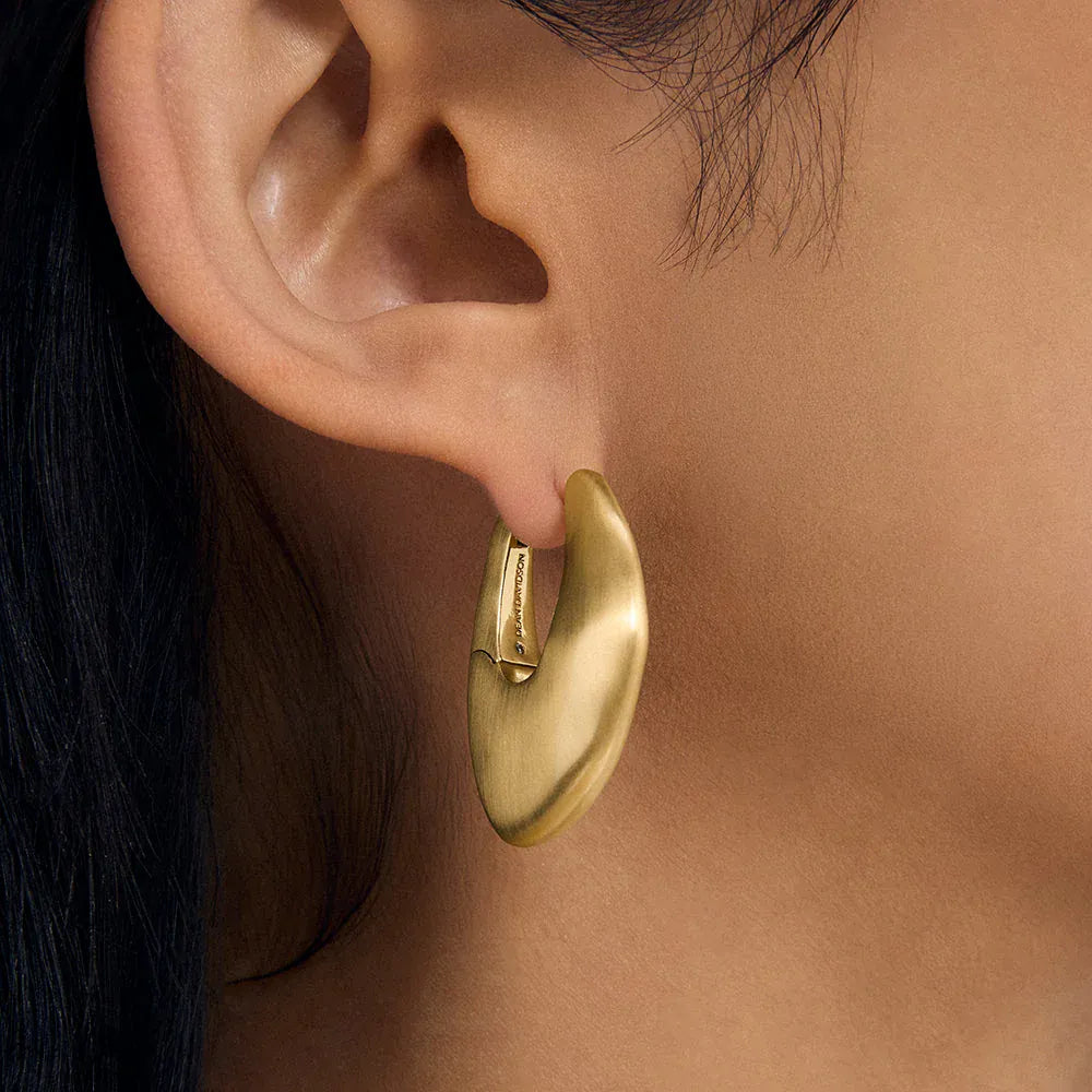Dean Davidson Serra Hinged Hoops in gold, close-up on ear