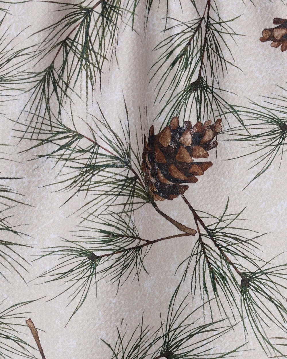Geometry Evergreen Frost Tea Towel featuring pine branches and pinecones on white