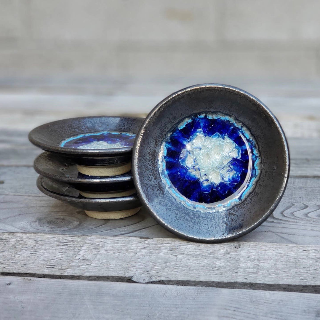 Dock 6 Pottery Tin Man ceramic ring dishes with fused glass centers, shown upright beside a stack; sold individually