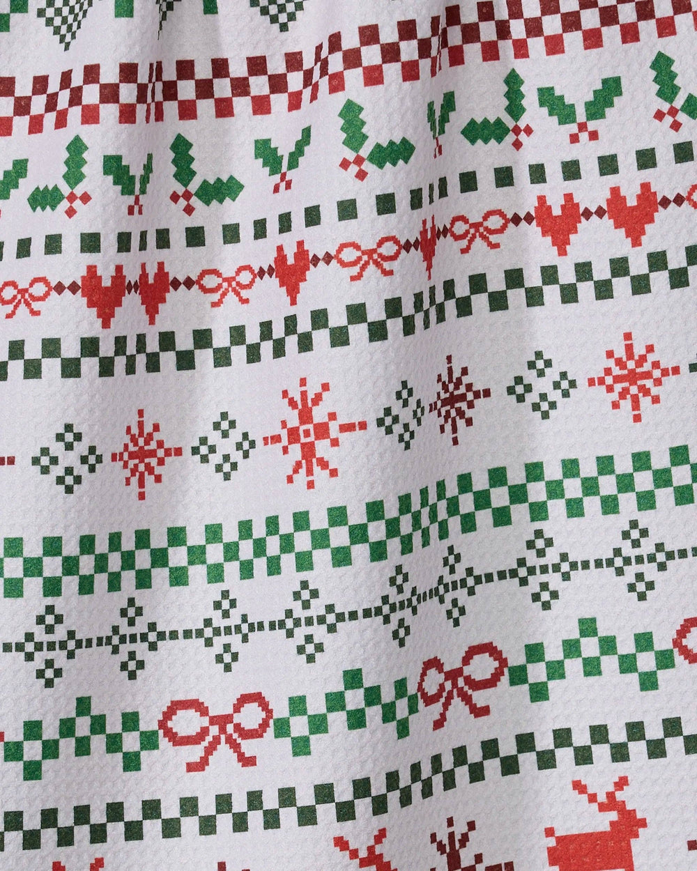 Geometry Ugly Sweater Day Tea Towel featuring red and green sweater-style rows of reindeer, hearts, bows and snowflakes