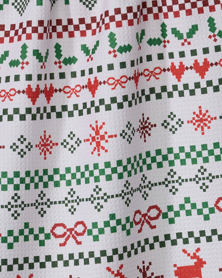 Geometry Ugly Sweater Day Tea Towel featuring red and green sweater-style rows of reindeer, hearts, bows and snowflakes
