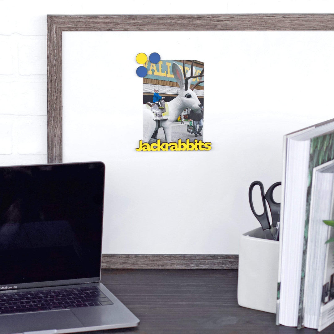 Yellow Jackrabbits wood word magnet holding a photo on an office magnet board