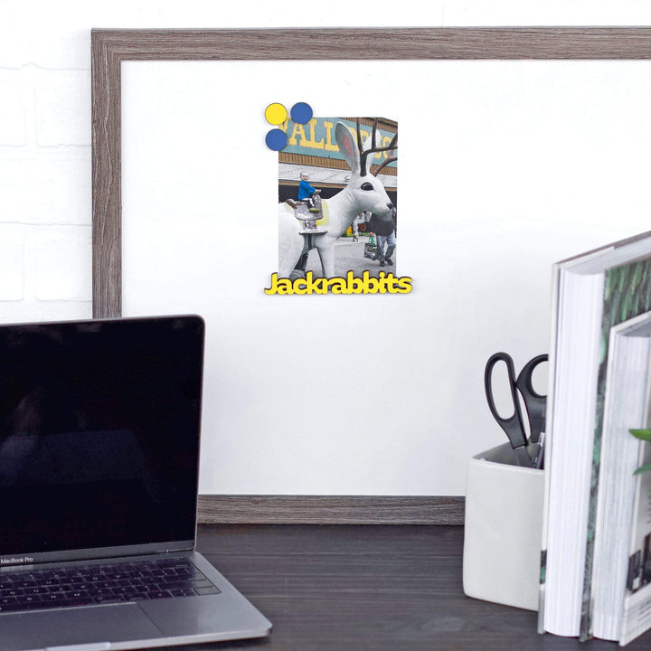 Yellow Jackrabbits wood word magnet holding a photo on an office magnet board